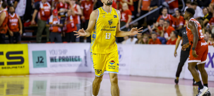 Jugador del Gran Canaria celebra en la cancha, con público animando de fondo.